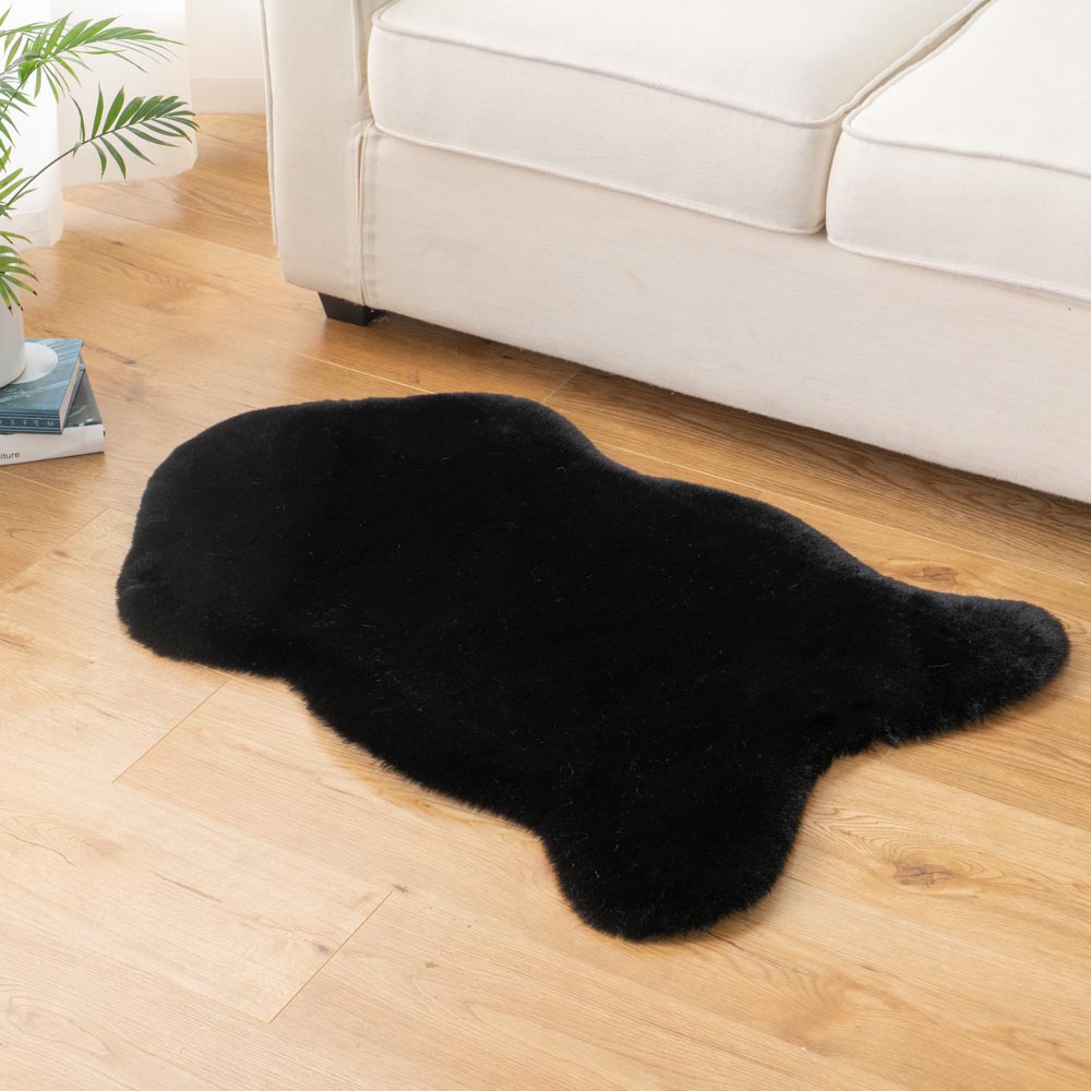 Black faux sheepskin rug, thick oval shag carpet for living room