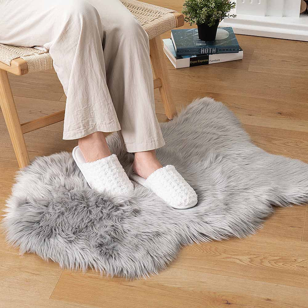 grey-faux-fur-sheepskin-chair-mat-rug.jpg Plush grey faux fur sheepskin rug styled as a chair mat or floor rug, perfect for global B2B sourcing and bulk buyers.