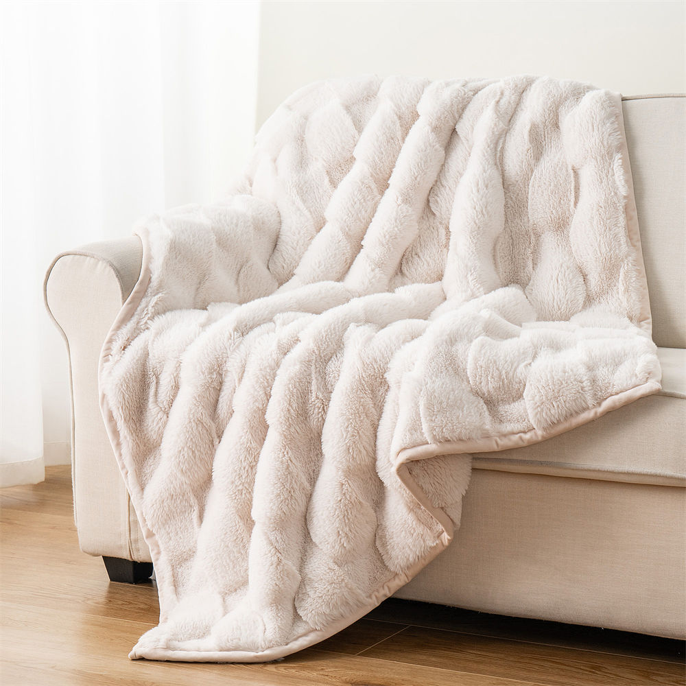 High-quality double-sided ripple faux fur throw blanket displayed on a beige sofa, suitable for home decor wholesalers.