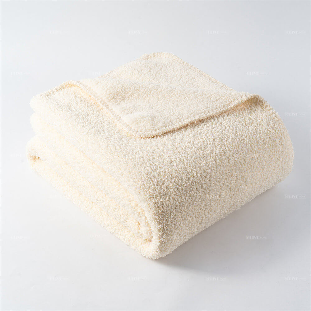 Neatly folded ivory microfiber chenille reversible throw blanket showcasing its plush, soft texture.
