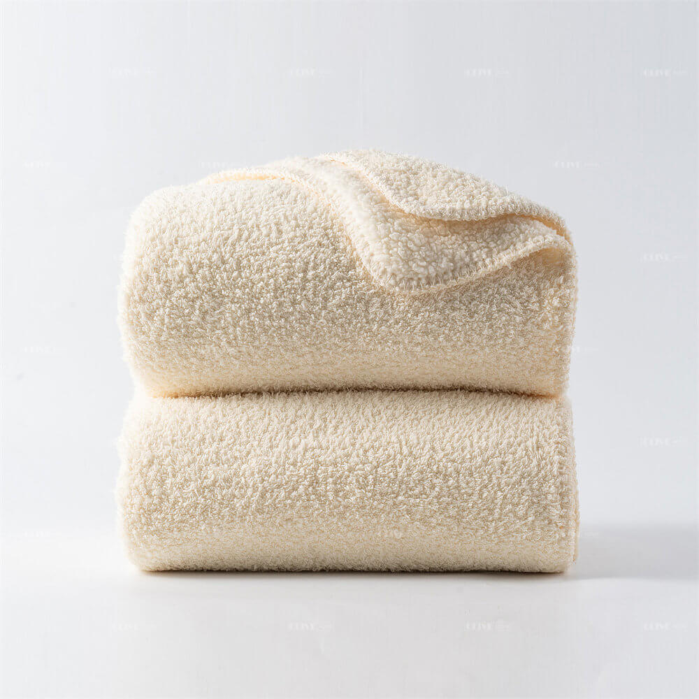 Stack of two cream microfiber chenille reversible throw blankets for bulk supply and wholesale order.