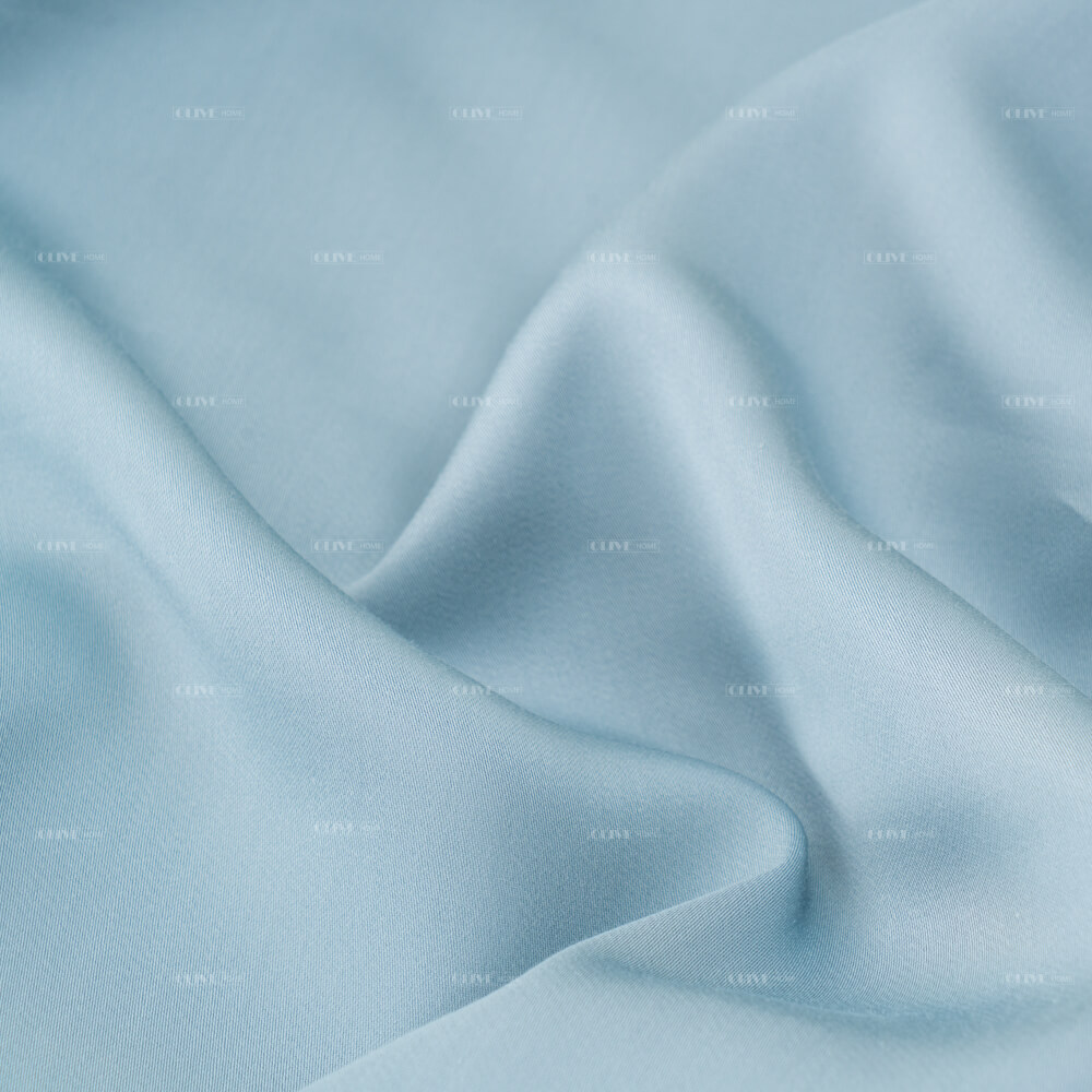 Close-up photography of silky smooth and naturally breathable light blue bamboo viscose fabric with soft elegant drapery.