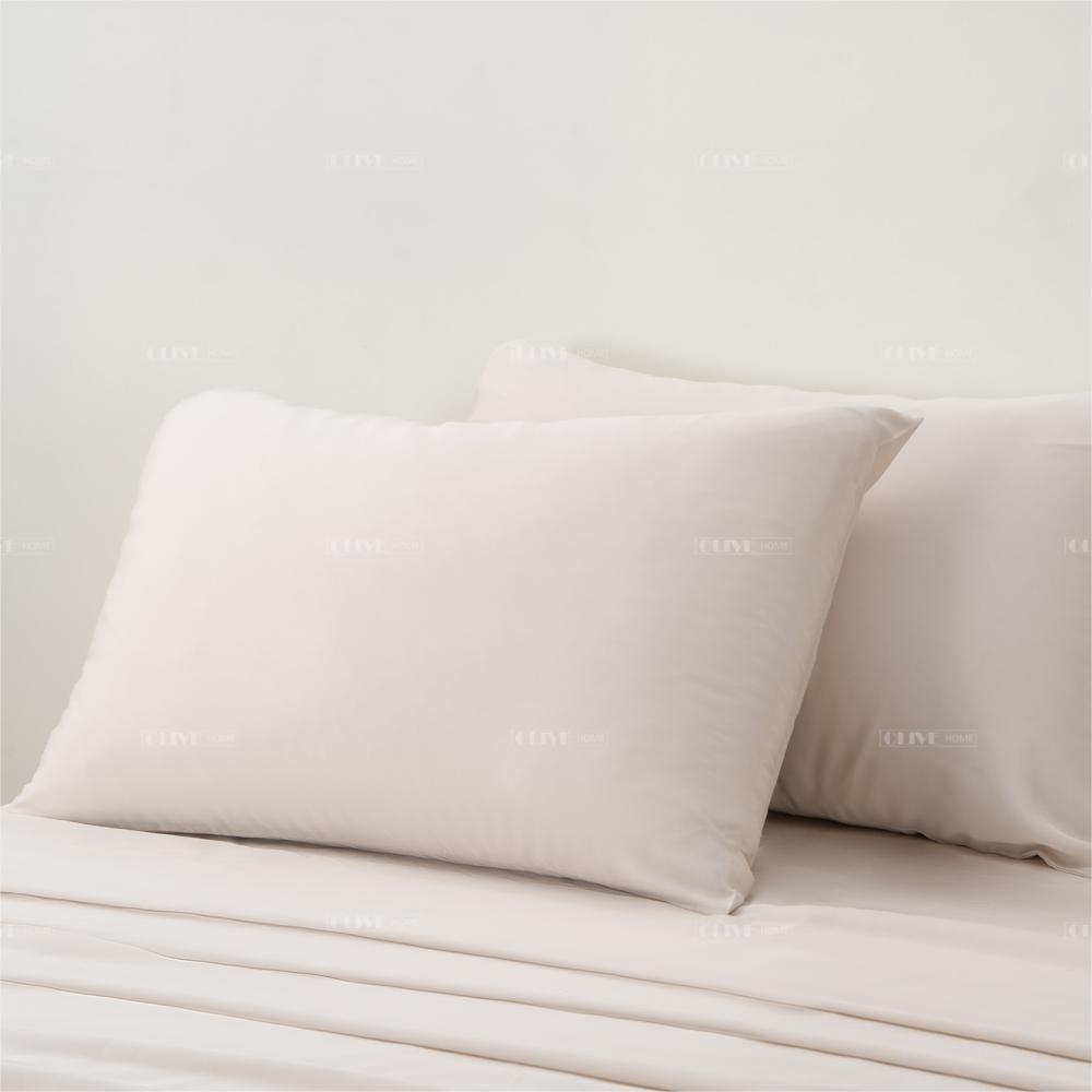 Luxury organic bamboo cooling pillowcases in cream beige color on a bed, available for custom orders and bulk wholesale.