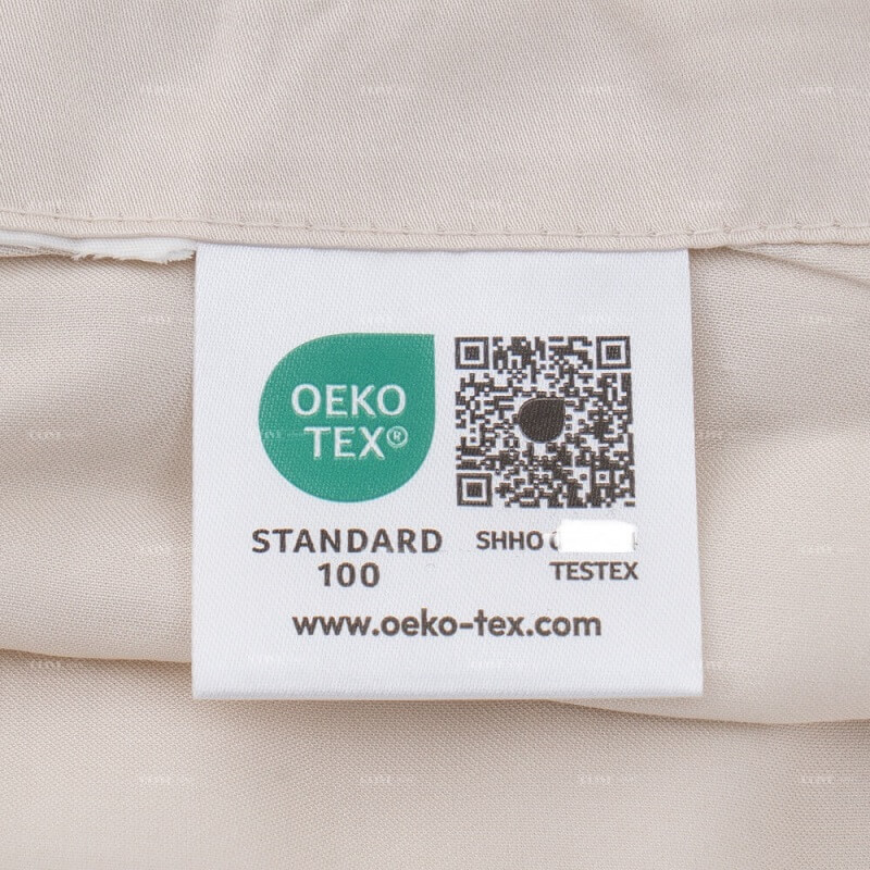 An Oeko-Tex Standard 100 certified eco-friendly label sewn onto the organic bamboo bedding, proving it is safe, chemical-free, and skin-friendly.