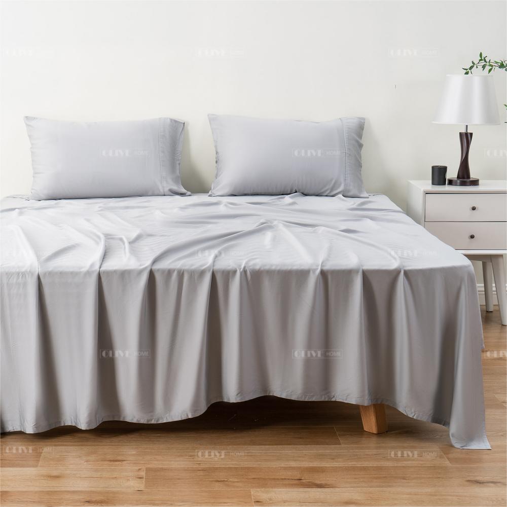 Full view of 100% organic bamboo cooling bed sheet set in light grey on a bed, including flat sheet, fitted sheet, and pillowcases.