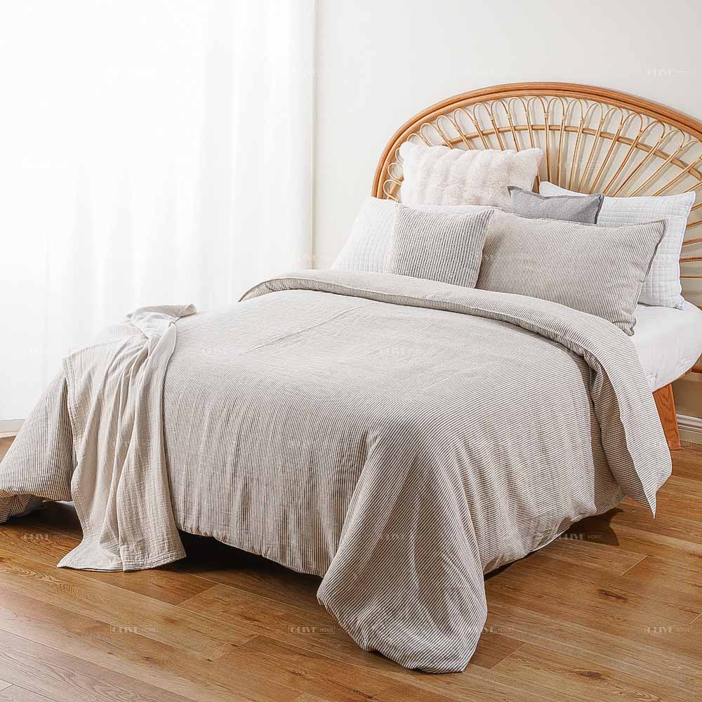 Grey and white striped premium French flax linen duvet cover set on a bed, luxury eco-friendly bedding for B2B wholesale.