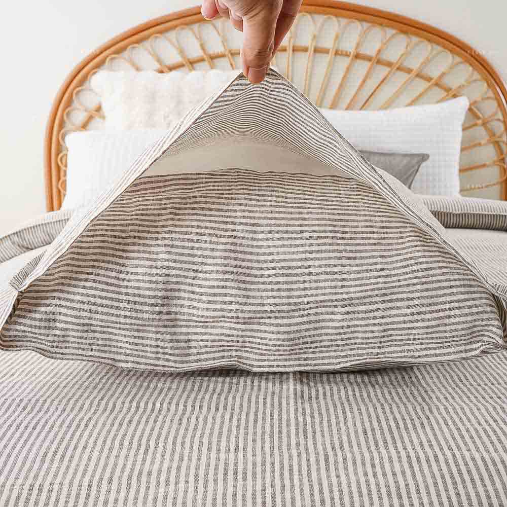 Envelope closure design on a striped French flax linen pillow sham, custom options for hotel linen supply and distribution.