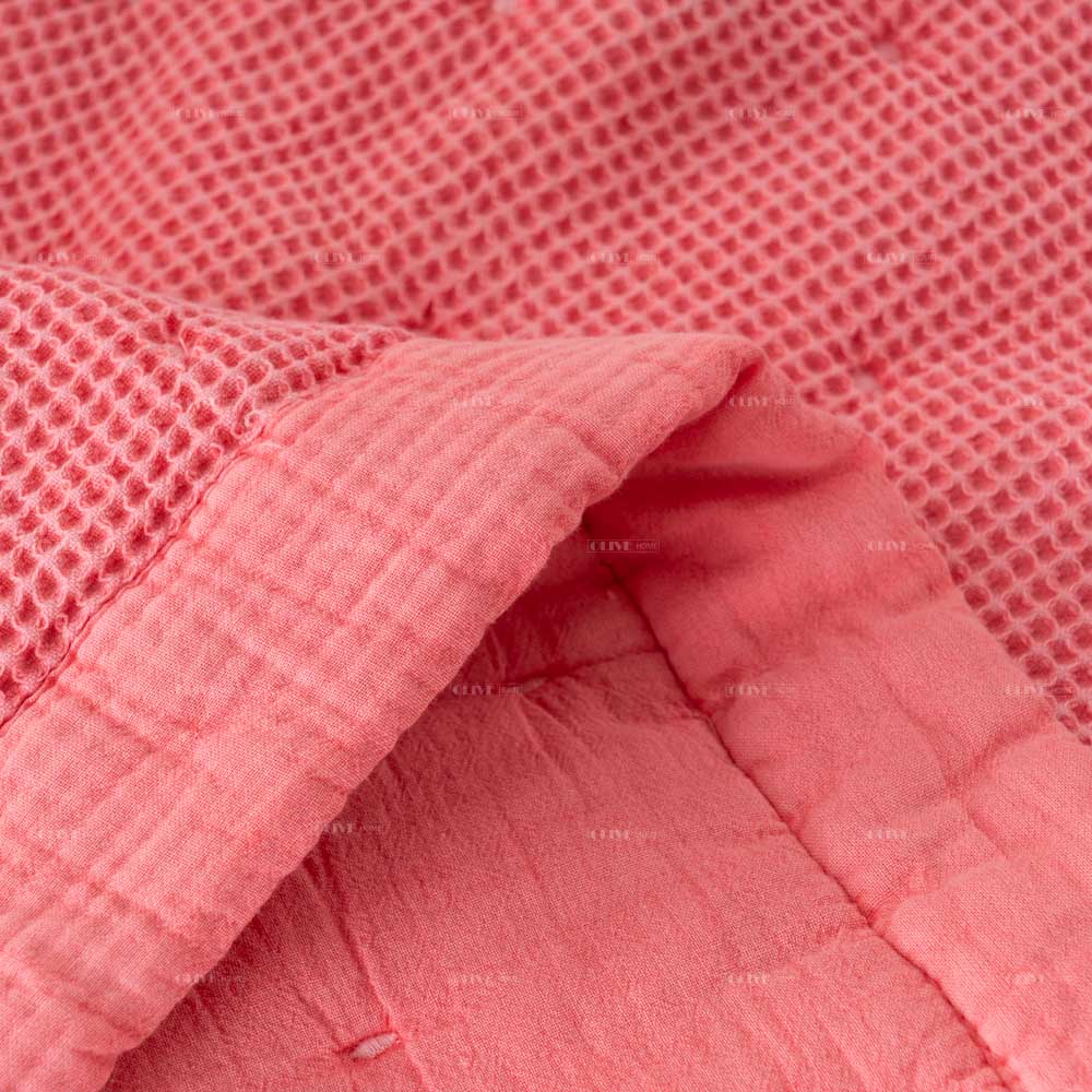 Mills waffle cotton quilt 5 Macro texture close-up of Peachy Pink Mills waffle cotton quilt showing honeycomb grid and soft crinkled gauze