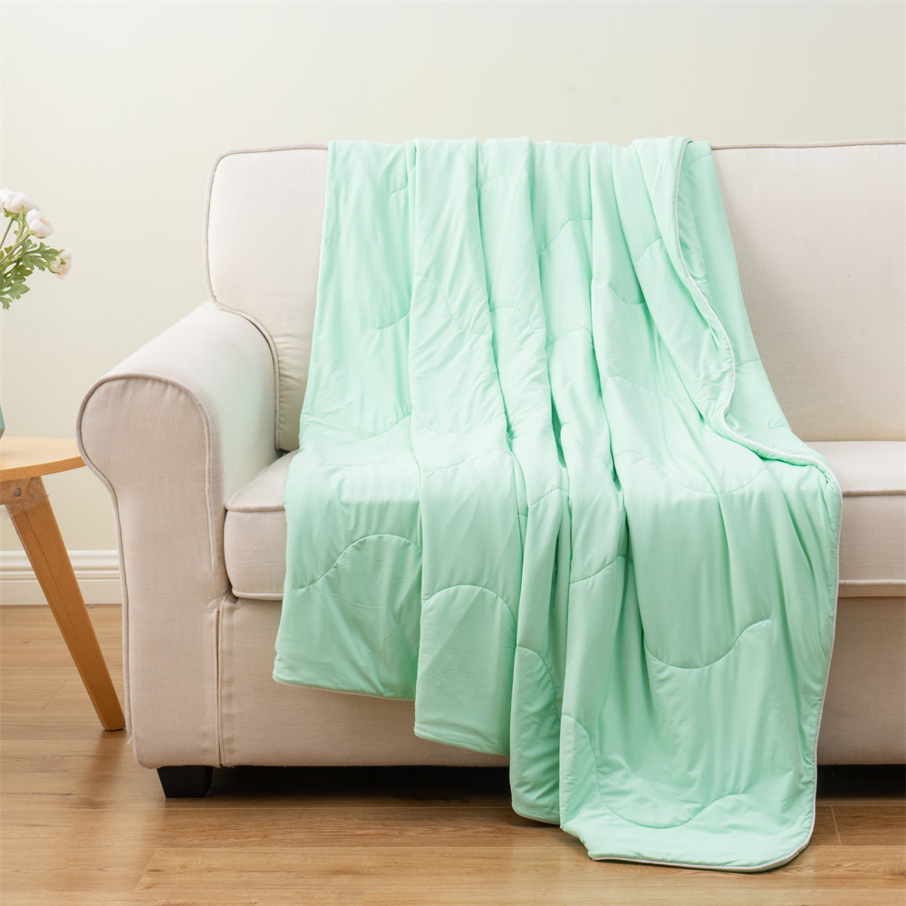 Lightweight cooling comforter wholesale factory direct, wave-quilted mint green summer blanket on sofa backdrop