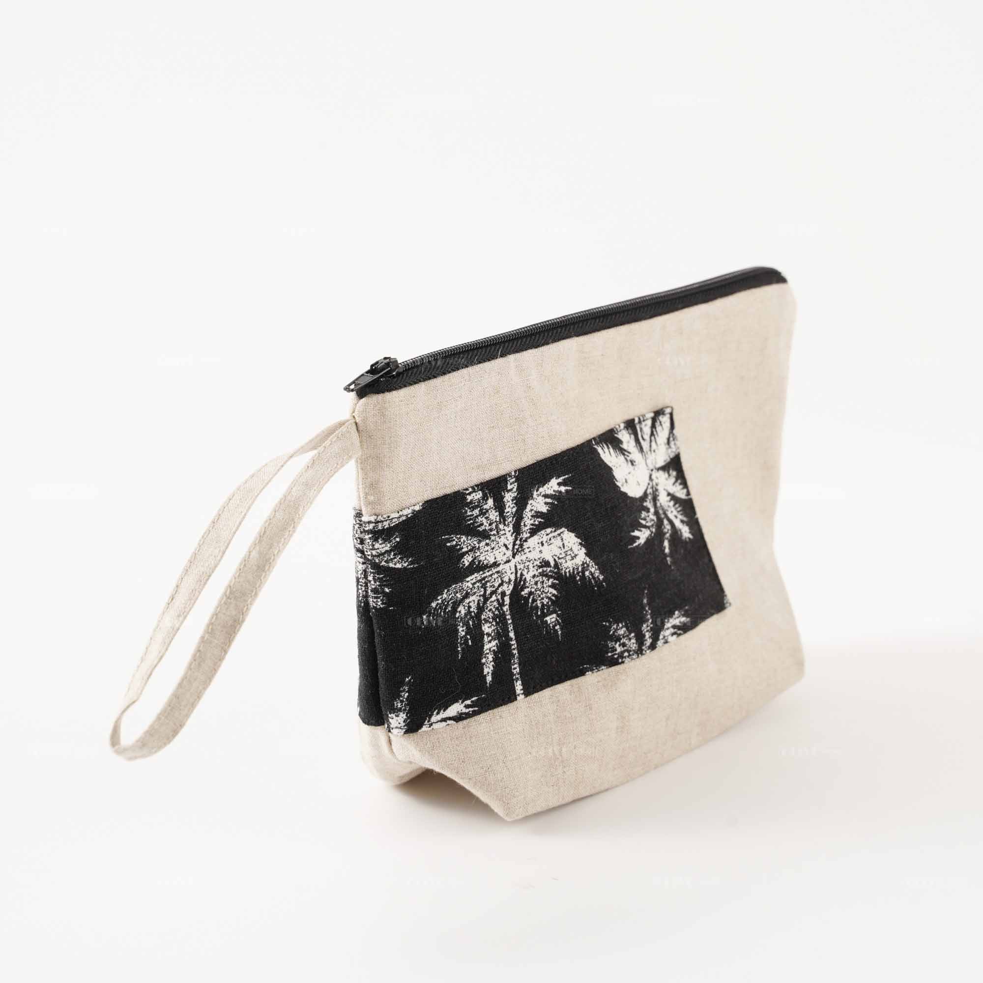 Side view of a standing flax linen cosmetic clutch bag with handle, highlighting its sturdy base and soft texture.