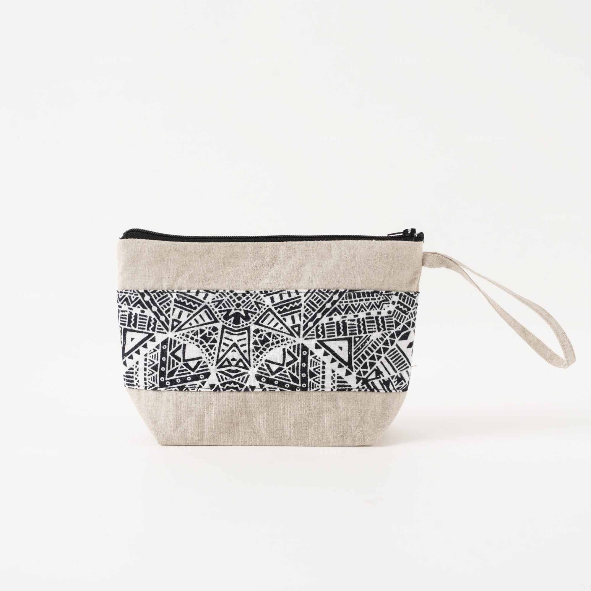 Front view of a natural cotton linen clutch bag with handle and a black-and-white geometric printed stripe.