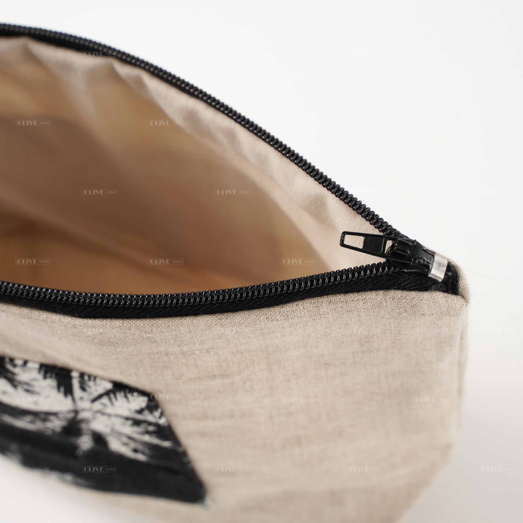 Interior look of a linen clutch bag, showcasing the smooth black zipper closure, premium inner lining, and spacious compartment for daily essentials.