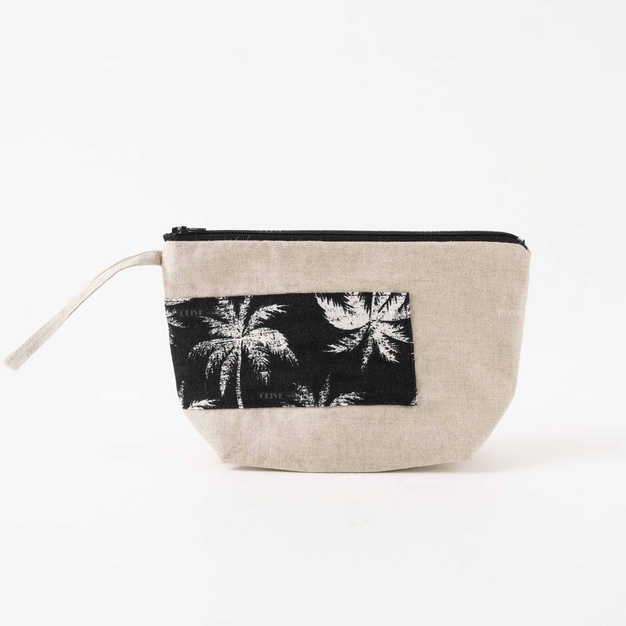 Eco-friendly linen clutch bag with wristlet handle and a tropical palm tree patch print design.
