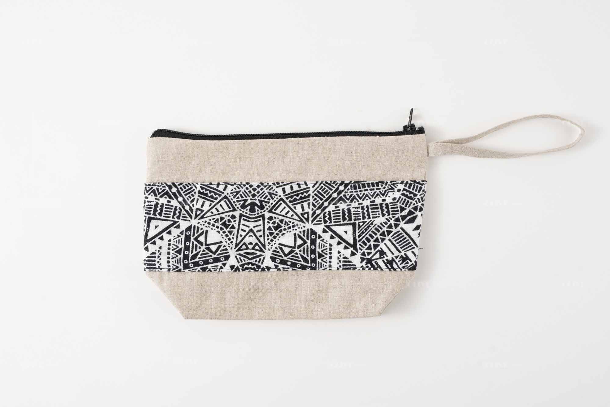 Flat lay view of a premium cotton linen wristlet clutch bag with an ethnic geometric pattern, suitable for custom branding.