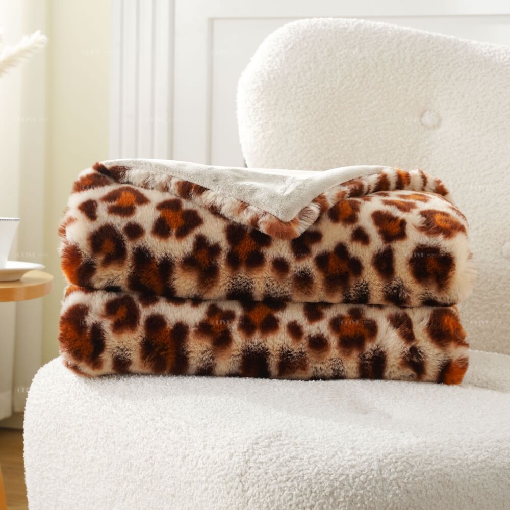 Folded cloud-like leopard faux fur blanket showing thick plush texture and soft reverse side for custom orders.